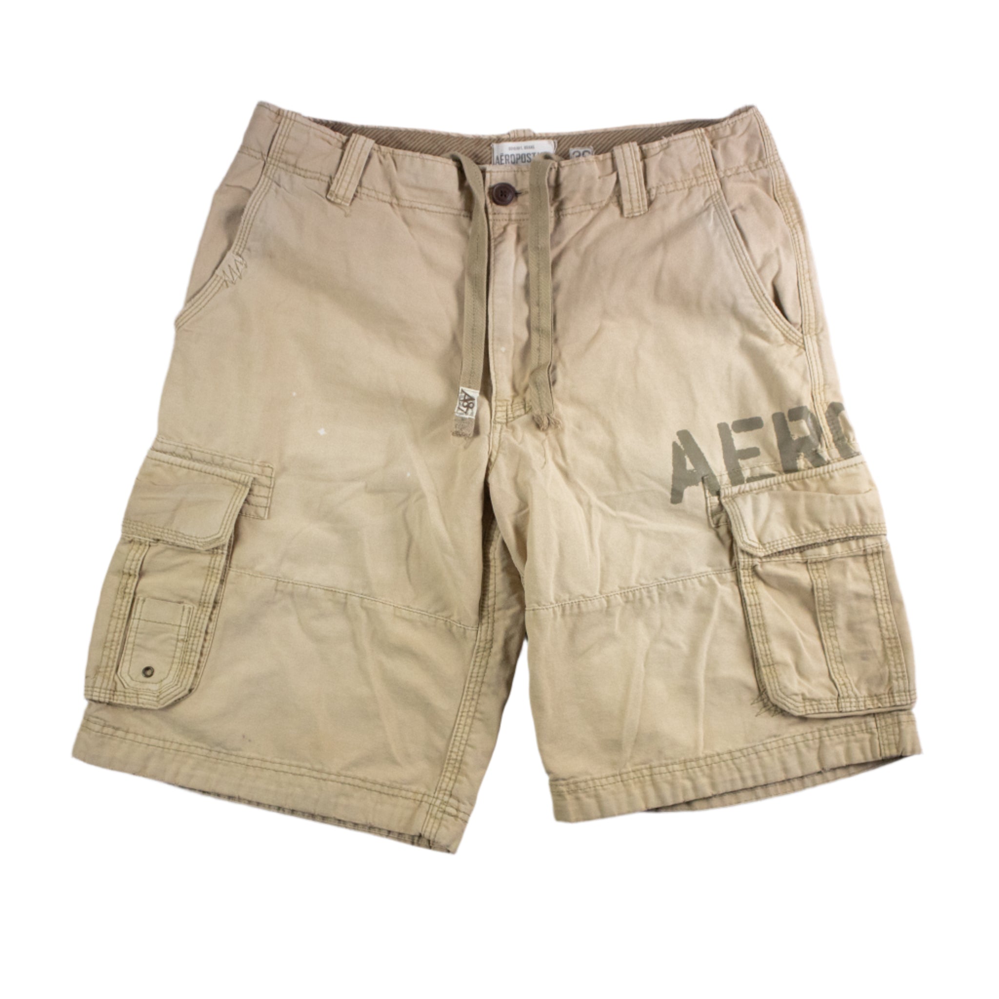 Beige cargo shorts with 'Aero' branding on a textured gray background