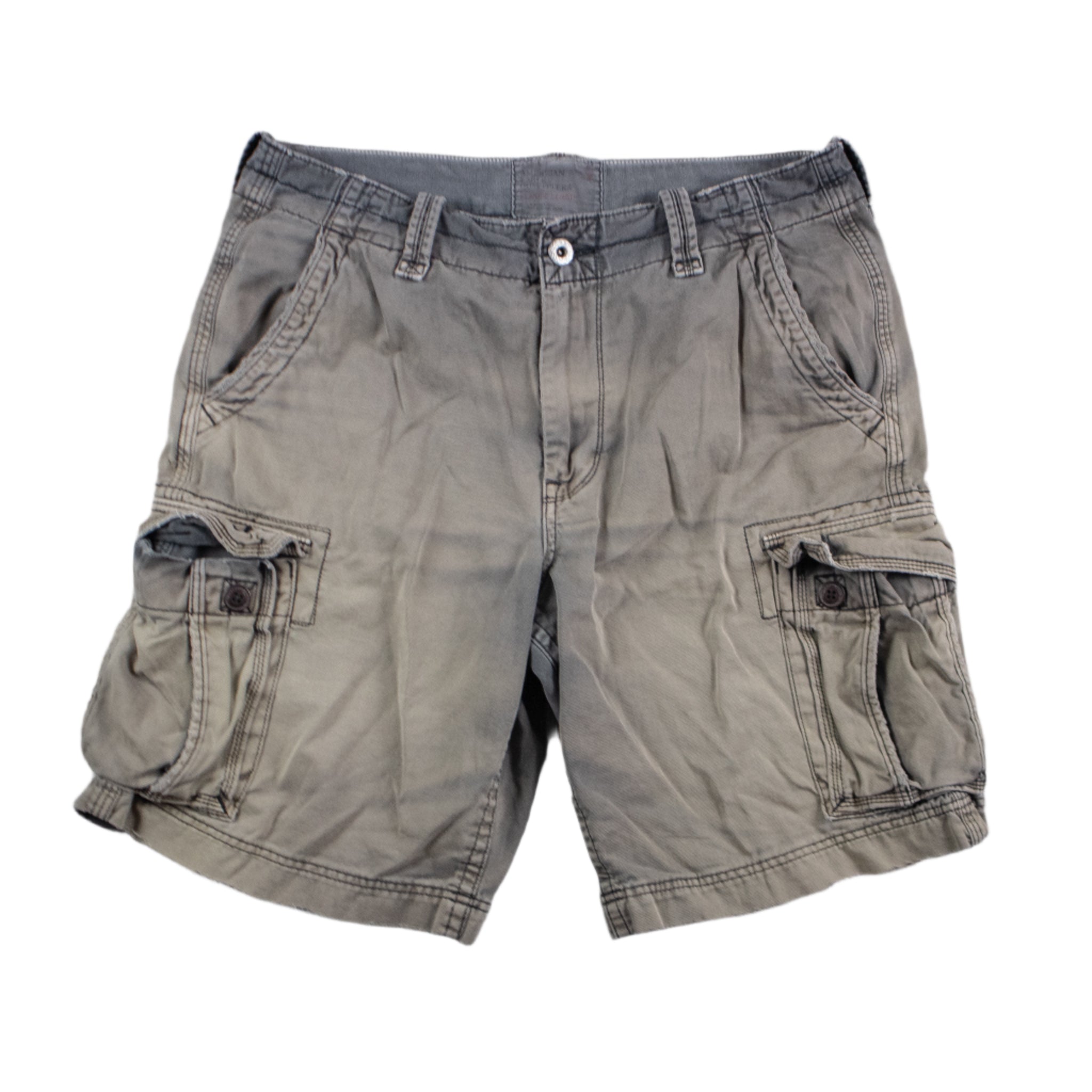 Beige cargo shorts on a textured gray background