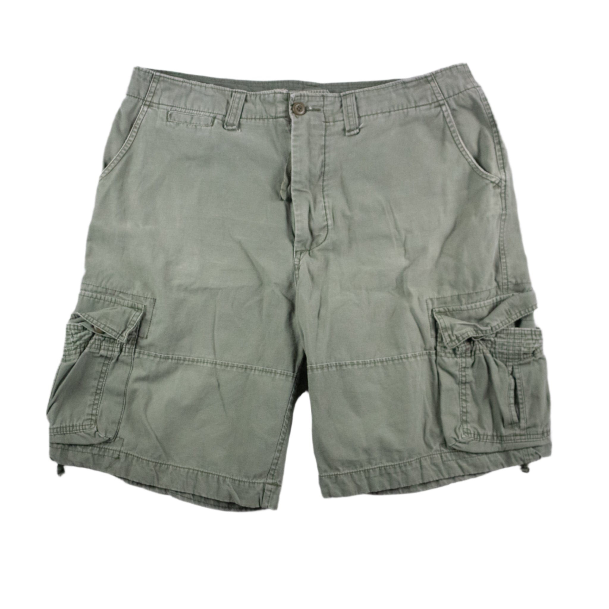 Green cargo shorts on a textured gray background