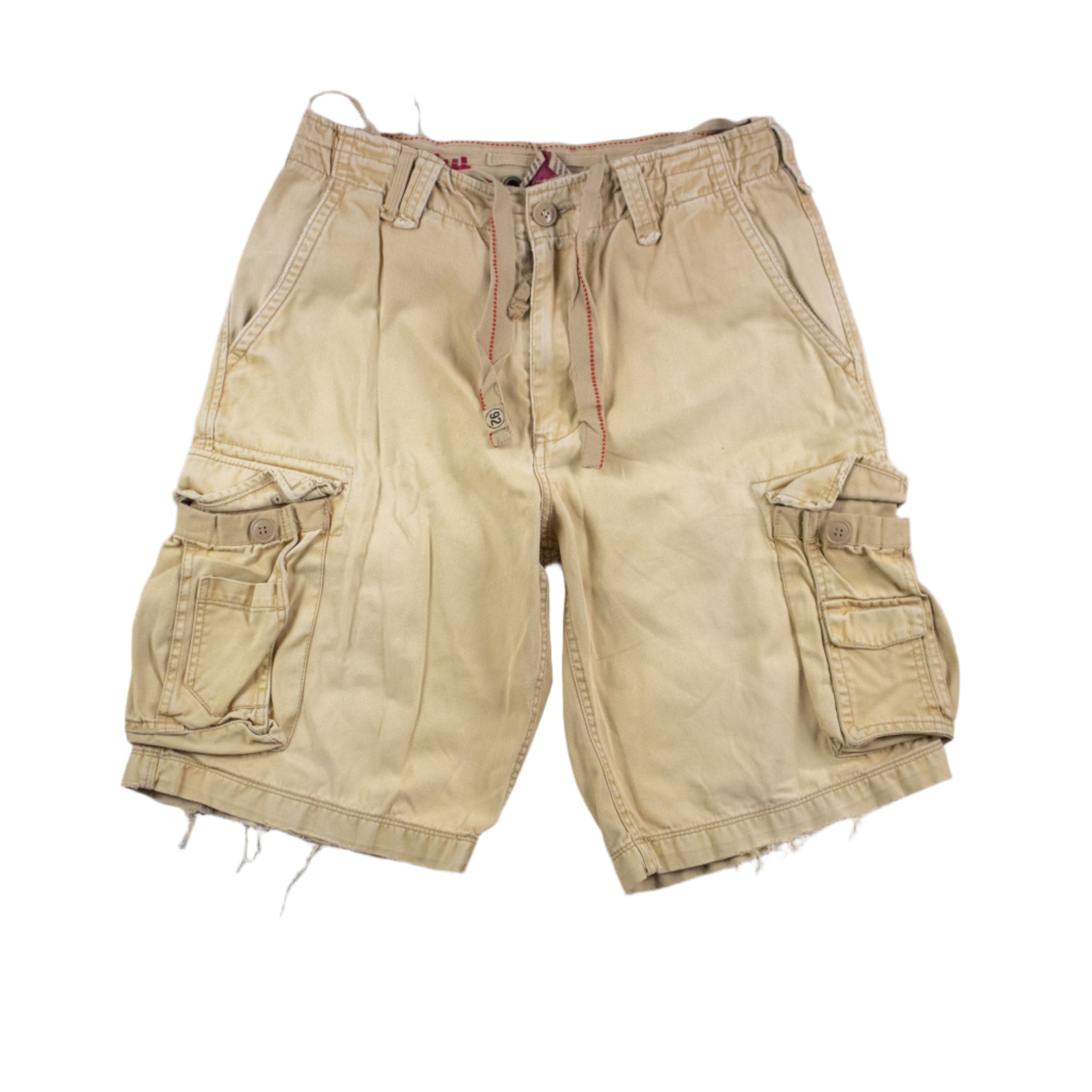 Beige cargo shorts on a textured gray background