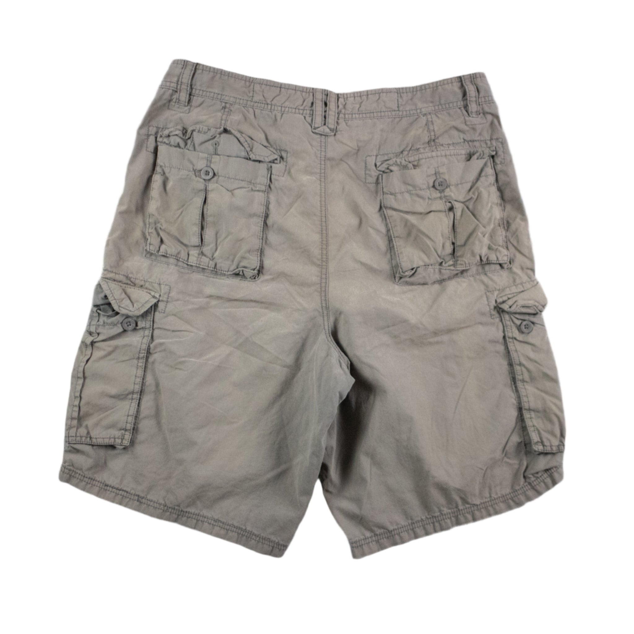 Beige cargo shorts on a textured gray surface
