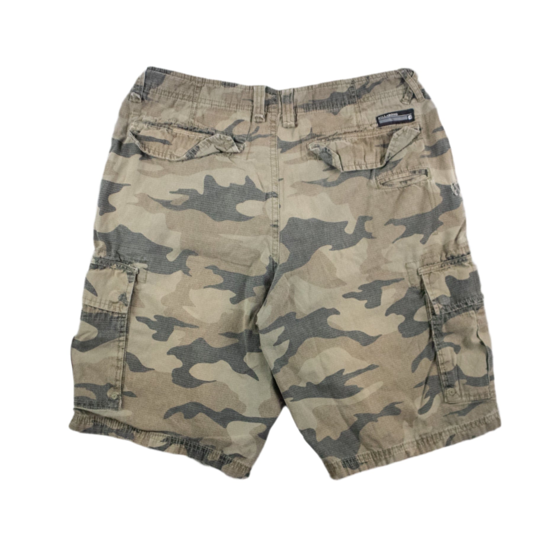 Camouflage shorts with a brand patch on a textured gray background