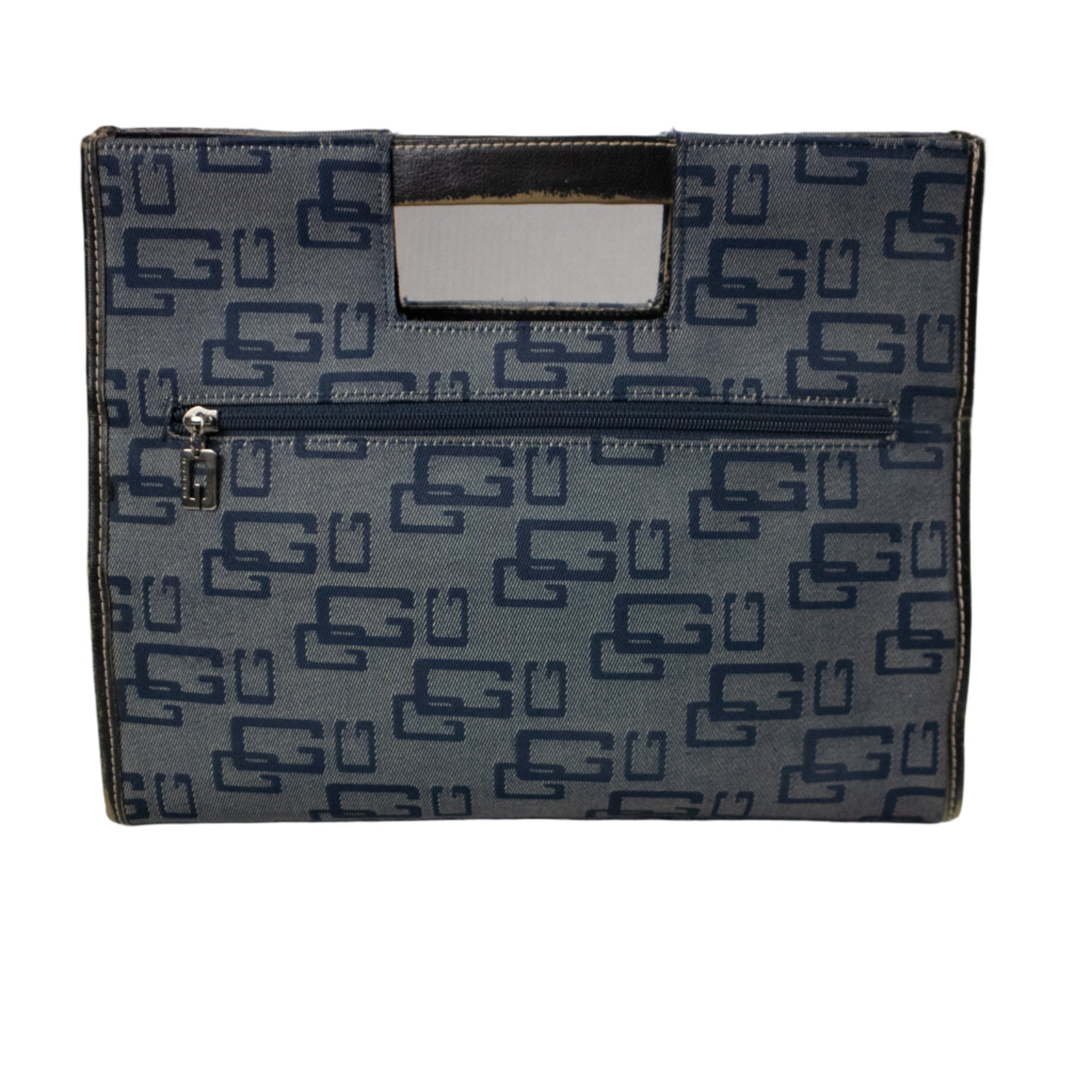 Blue patterned handbag on a white surface with a gray background