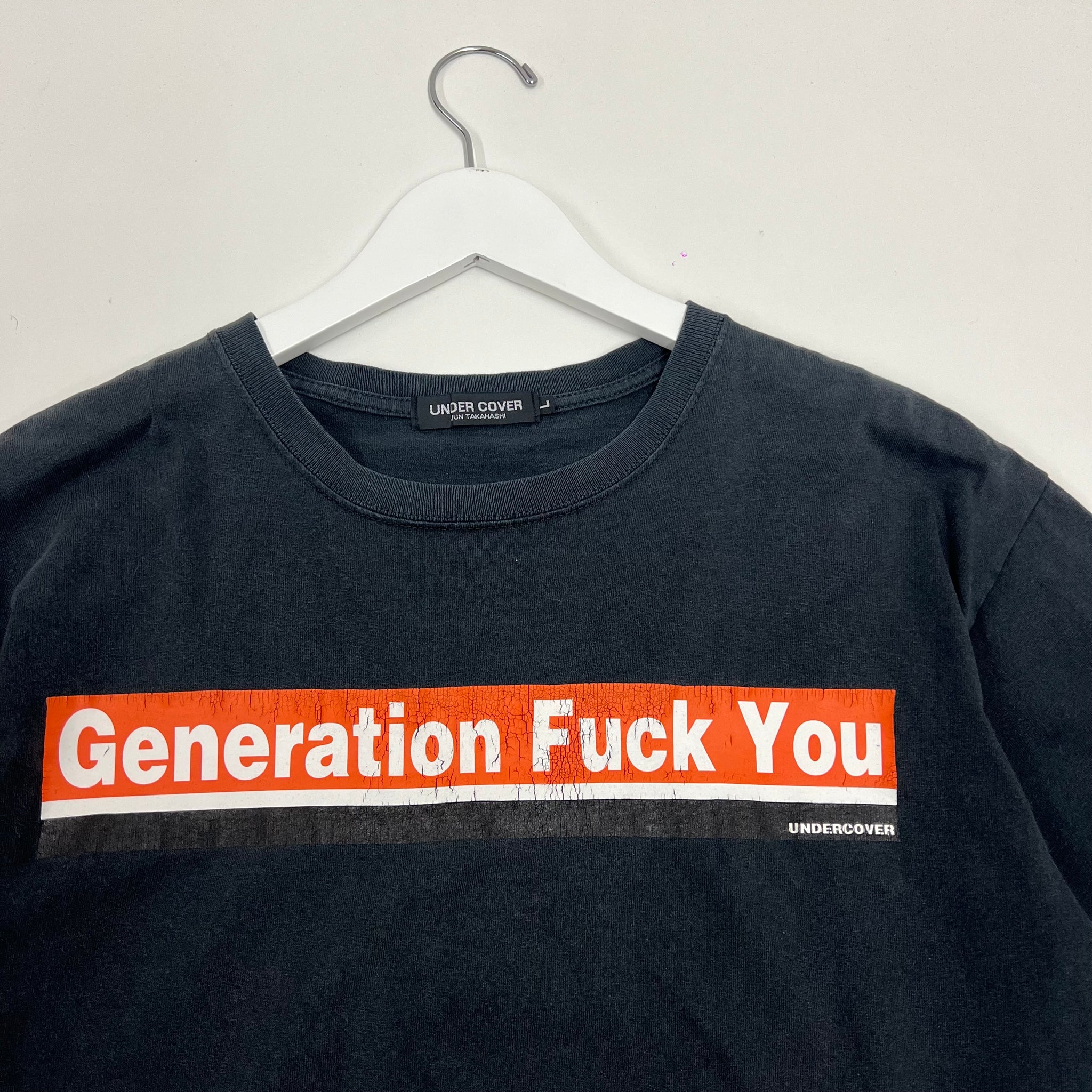 Undercover ‘Generation Fuck You’ T-shirt featuring bold slogan text across the front. Iconic punk-inspired graphic from Jun Takahashi’s archive