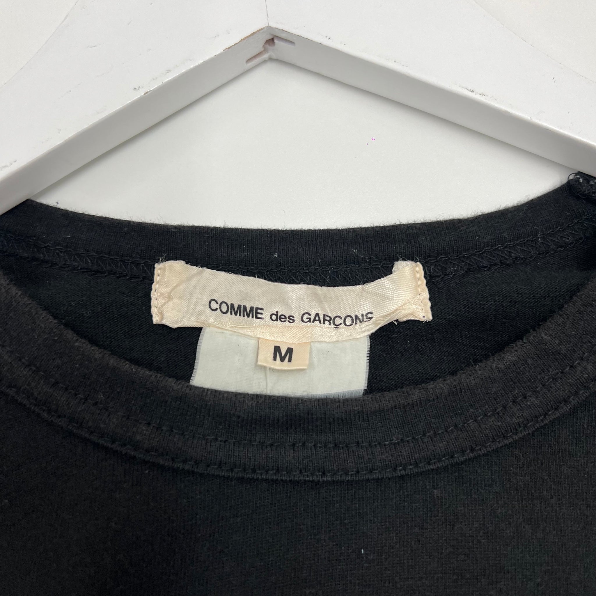 Comme des Garçons strap shirt featuring deconstructed detailing with fabric straps across the body. Avant-garde tailoring from Rei Kawakubo’s experimental collection