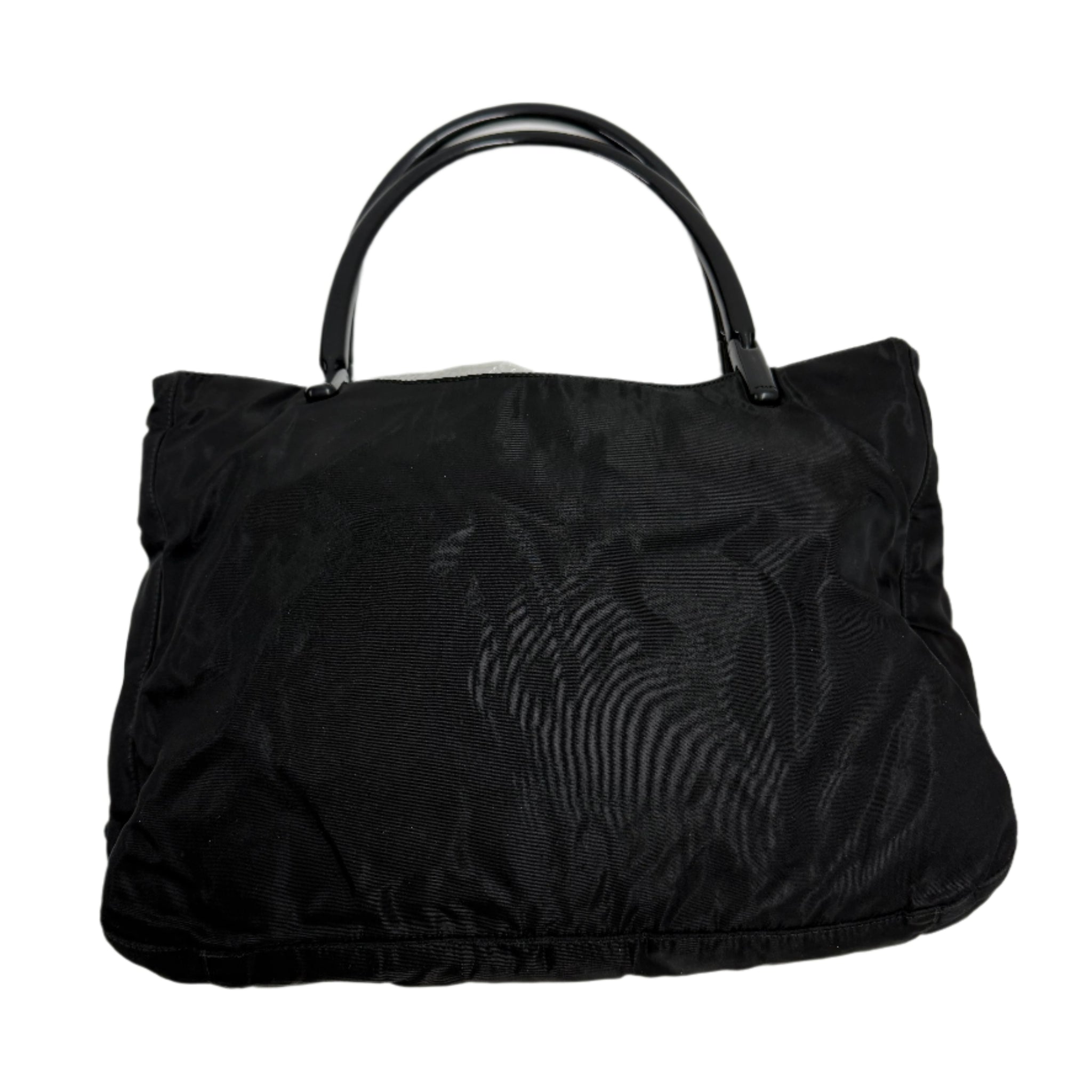 Black handbag on a light gray background Prada highend designer nylon luxury